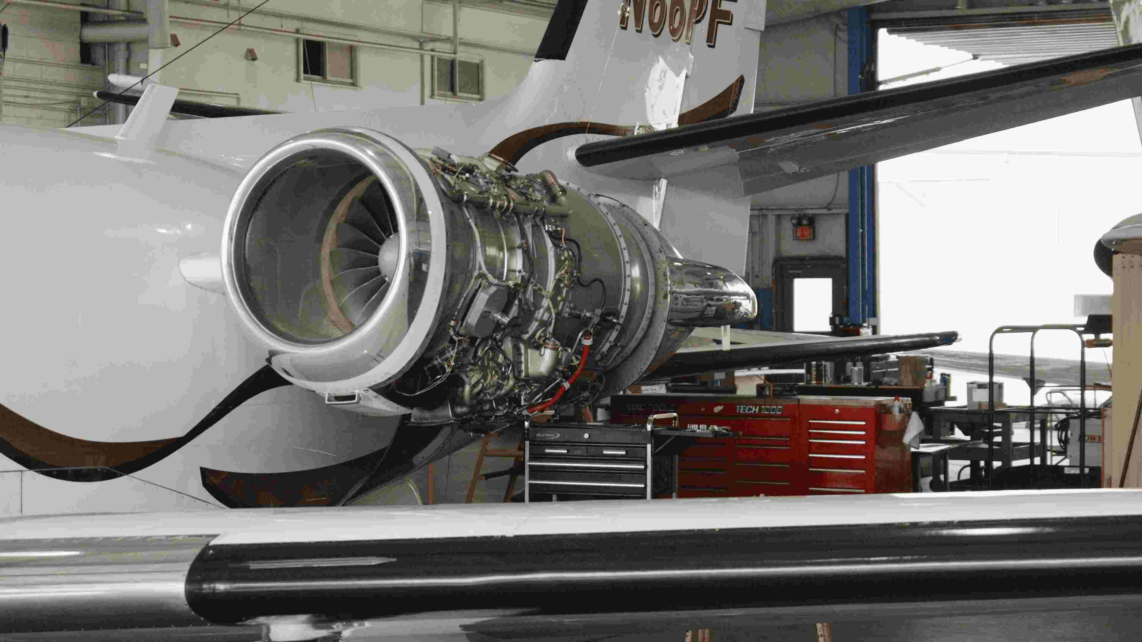 Jet engine maintenance with cowling open in hangar